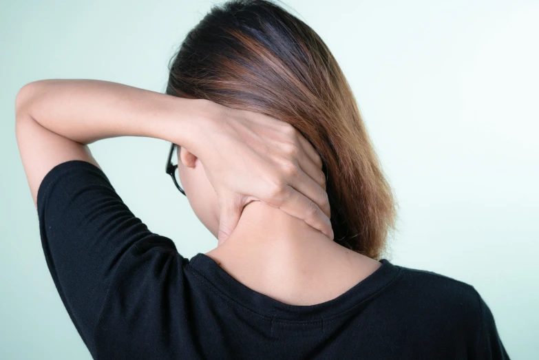 a woman with her hand on her hair