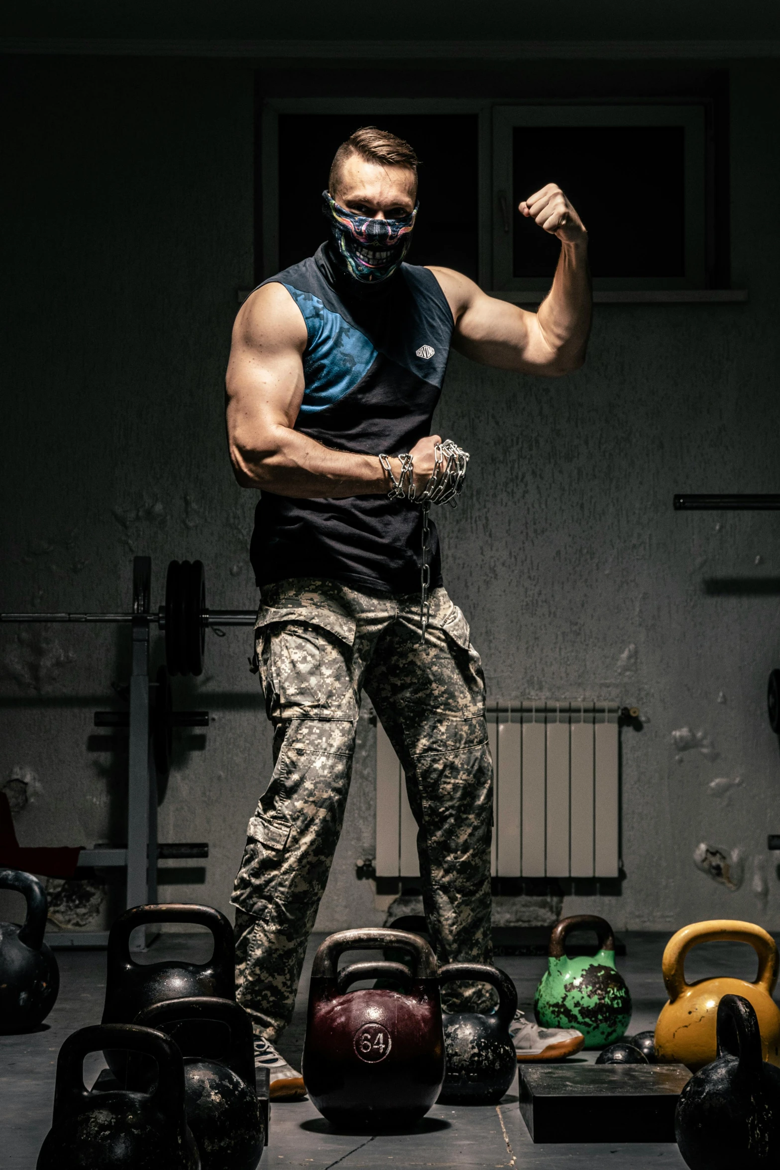 a man in camouflage gear standing on kettles