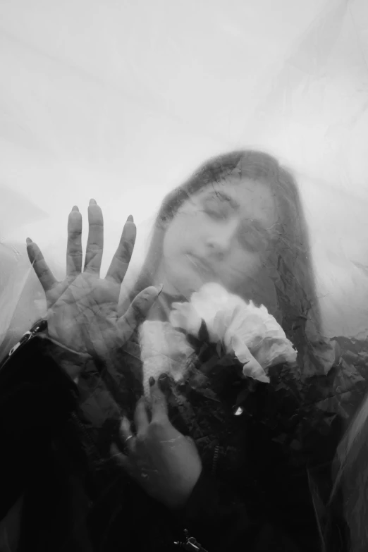 a black and white po with hands holding flowers