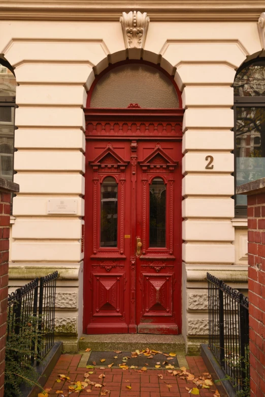 a red door on a cream building