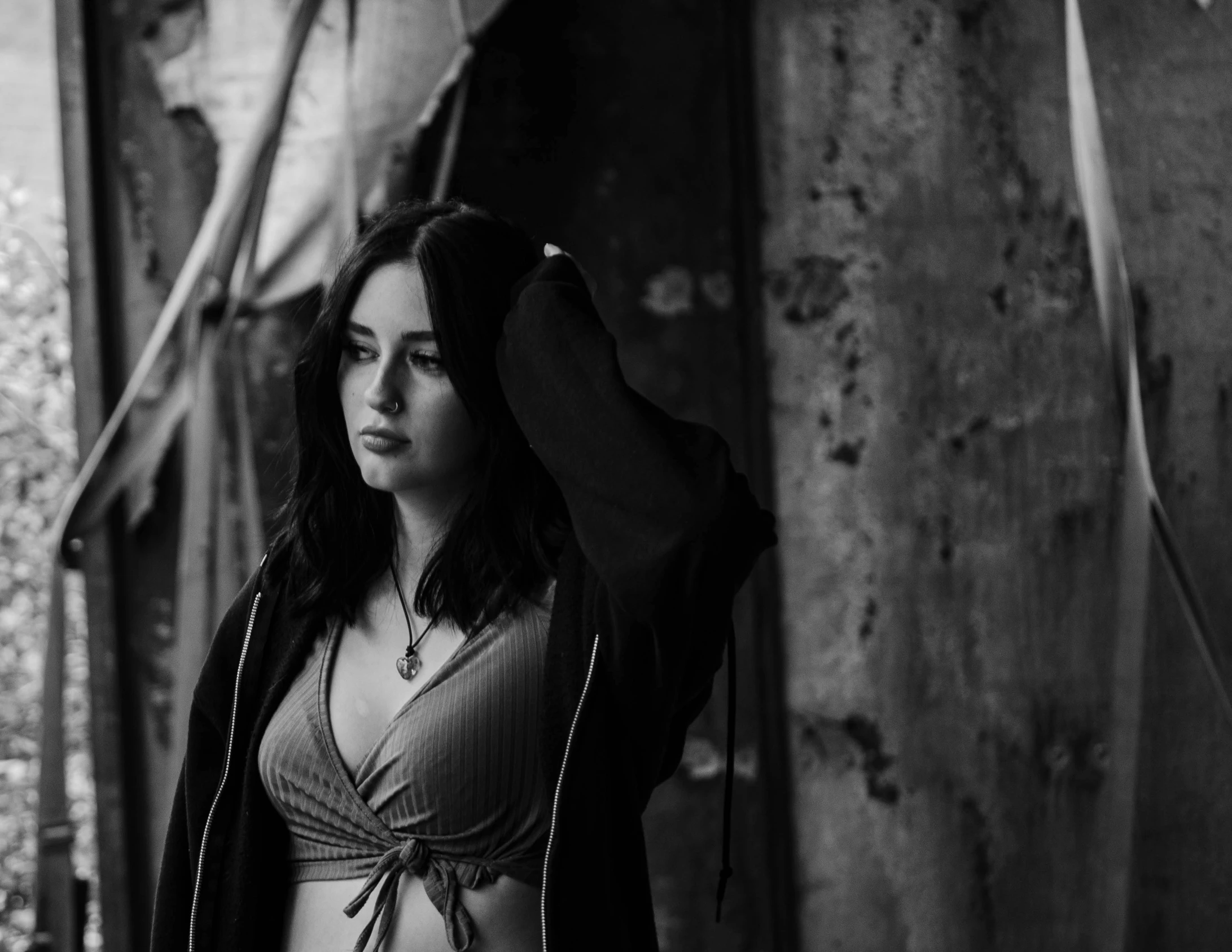 a young woman is leaning against a wall