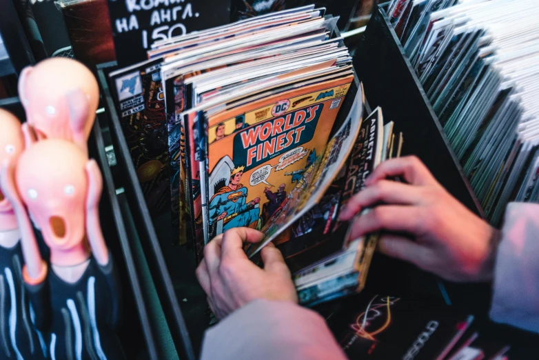 a woman picking up a cd from a record store shelf