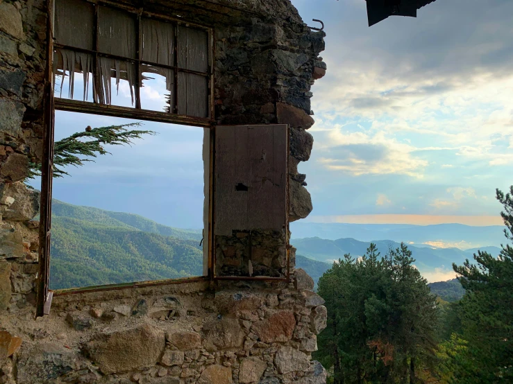 a broken window that is open on a building