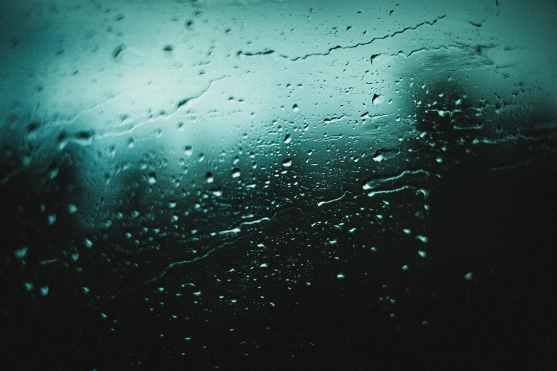 a window with rain on it and dark sky