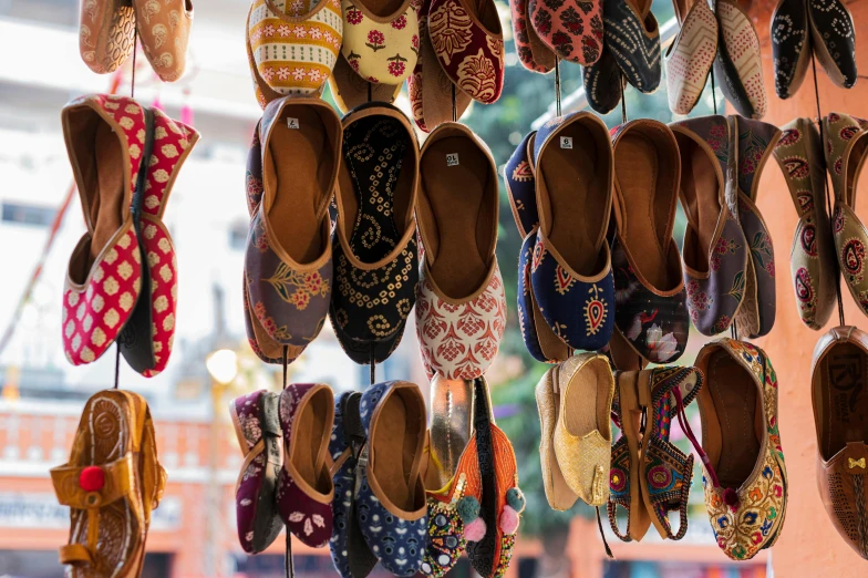 many shoes are hung together in a store