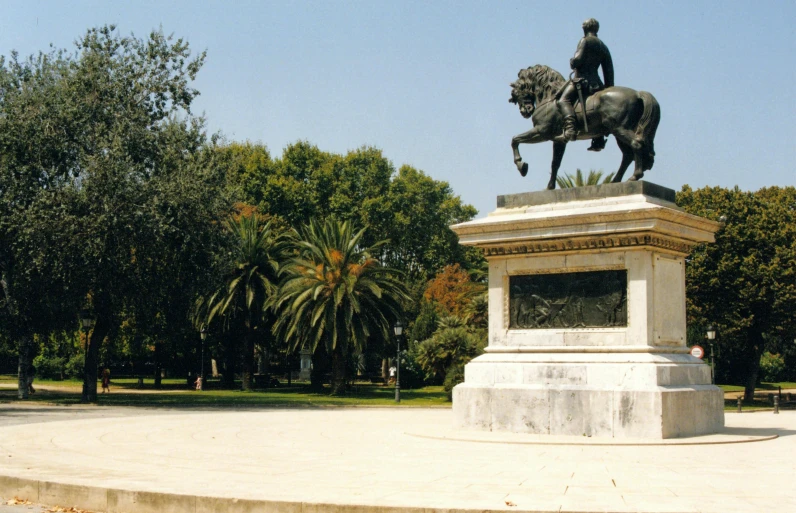 a statue is shown with a man on a horse in the foreground