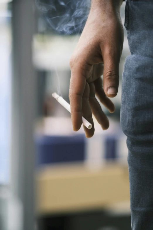 a man is smoking a cigarette outside