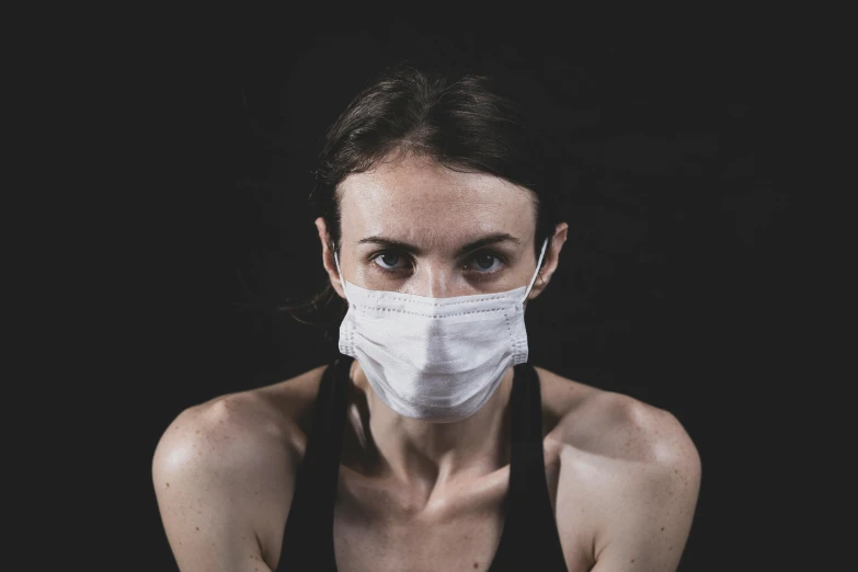 a woman is shown wearing a surgical mask