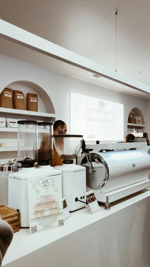 a person sitting at a counter with a coffee machine