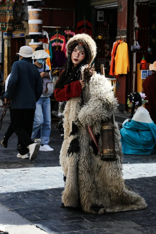 a person with a fur coat walking on a street