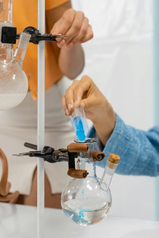 some people in a lab filling bottles with liquid