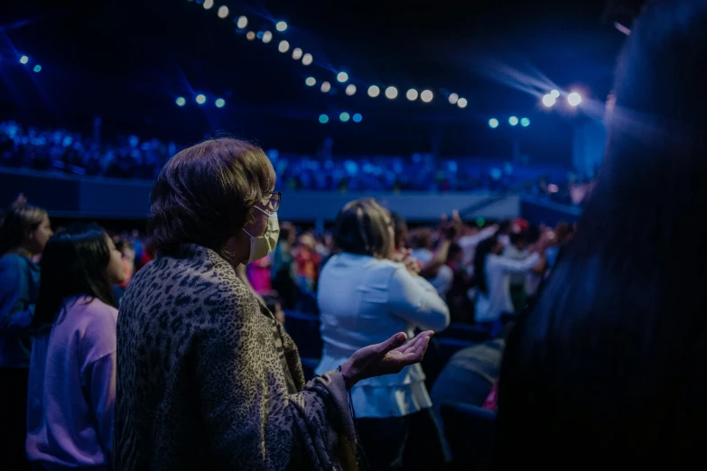 a woman in a crowd in a darkened room