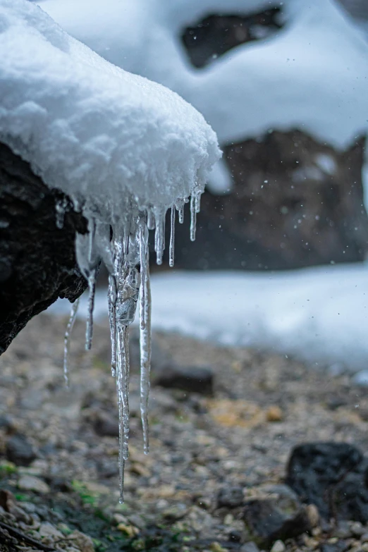 icicles are hanging from the roof of an old car