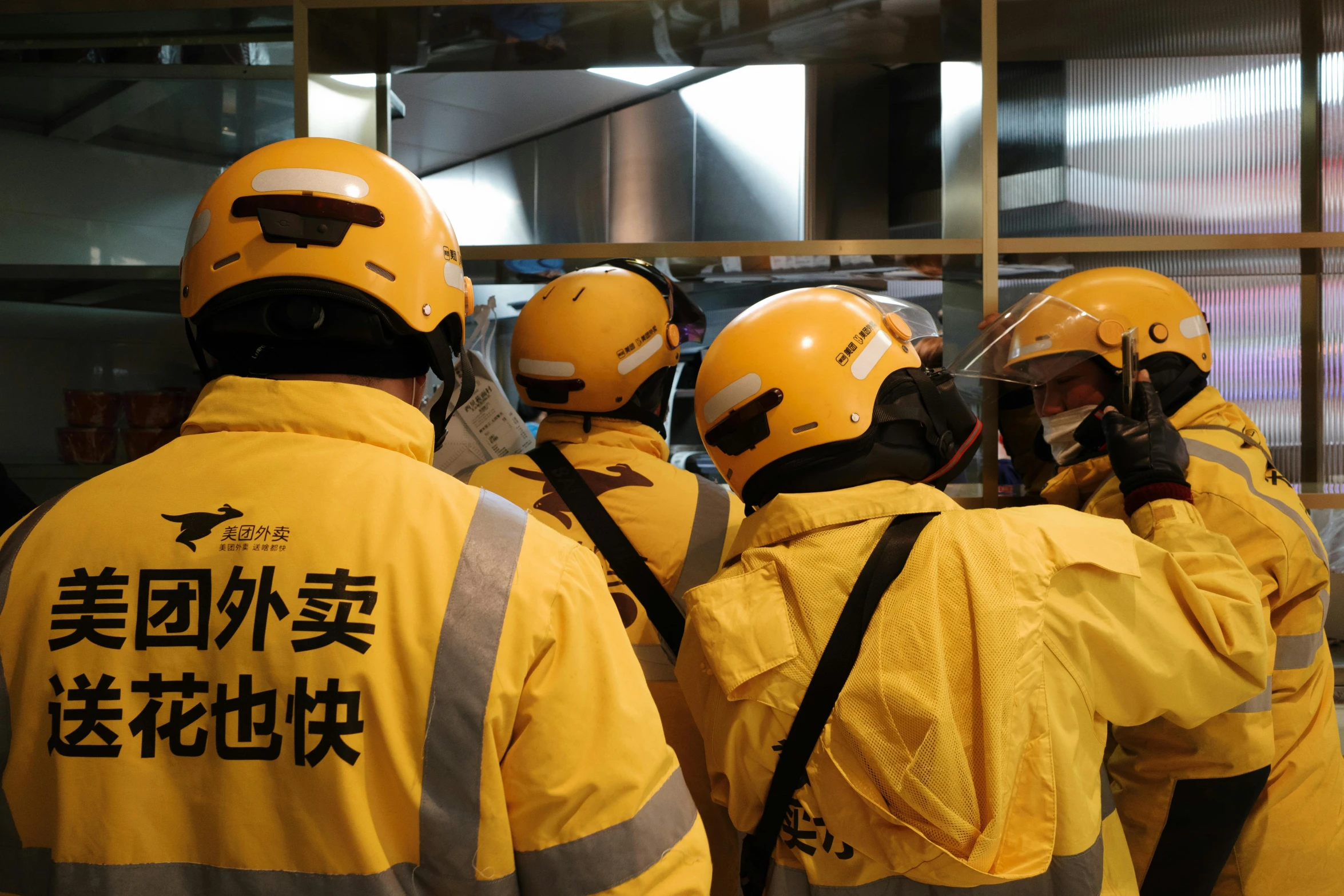 several rescue workers in yellow jackets talking