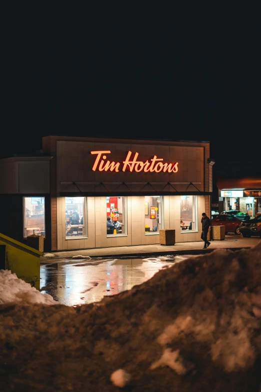 a tim hortons building is shown at night