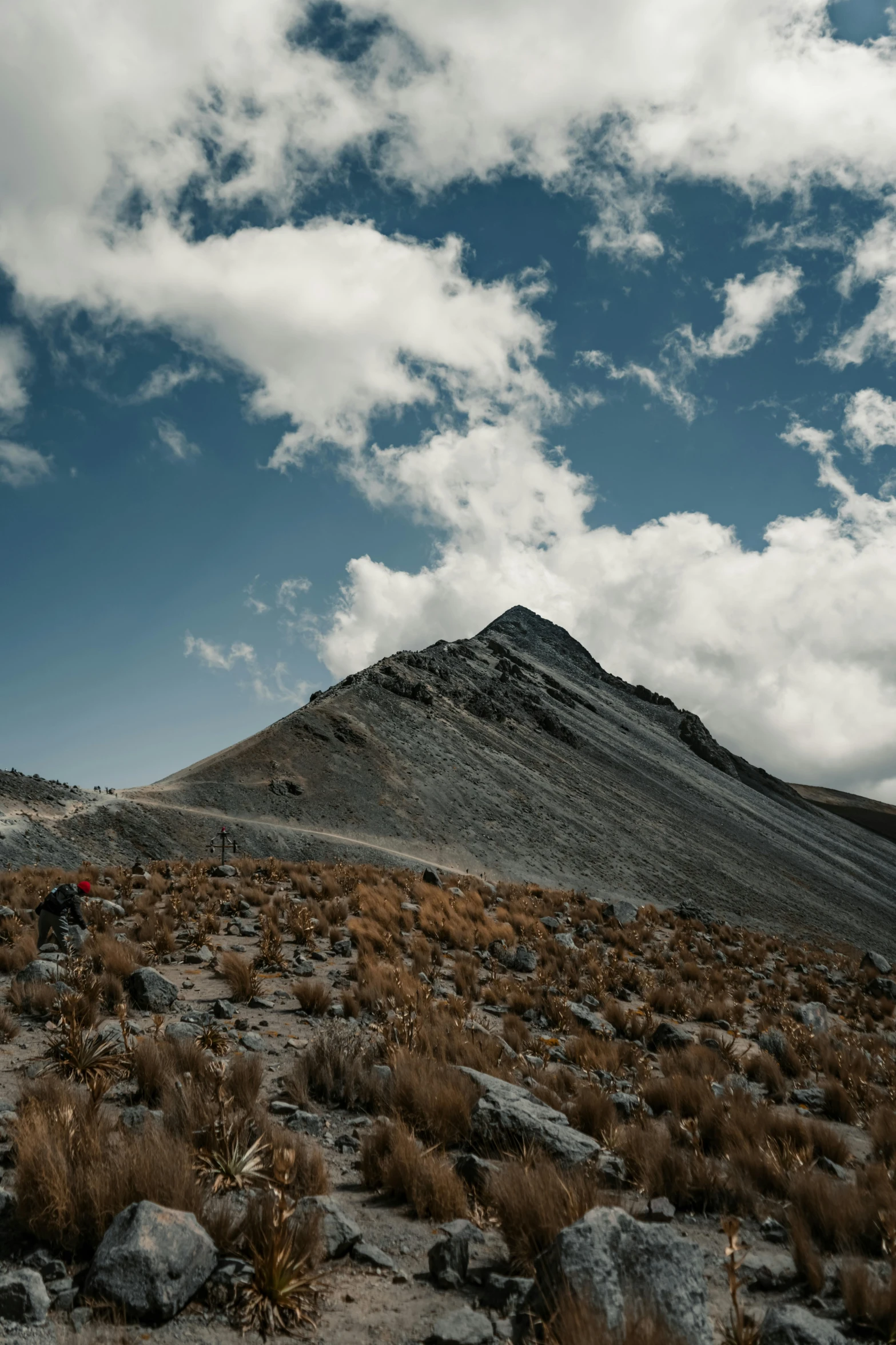 a lone bus is parked in the mountains