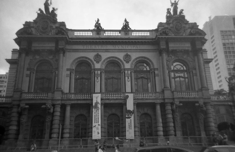 a woman is walking in front of an old building