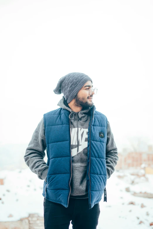 a man is standing on top of a snowy hill