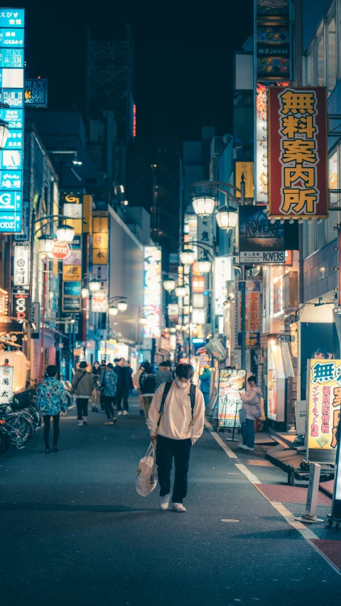 many people walk in an asian street at night