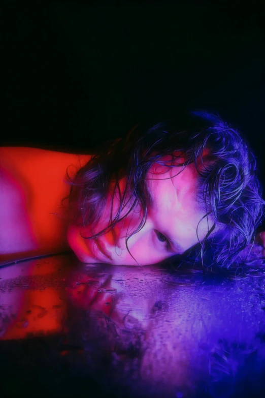 a girl with wet hair is laying down on her stomach