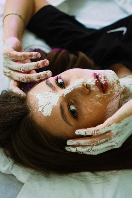 a  having her face painted white