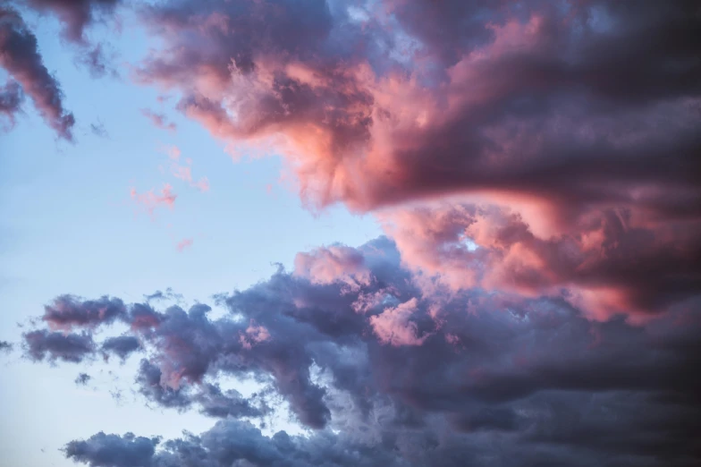 an airplane is flying through a cloudy sky