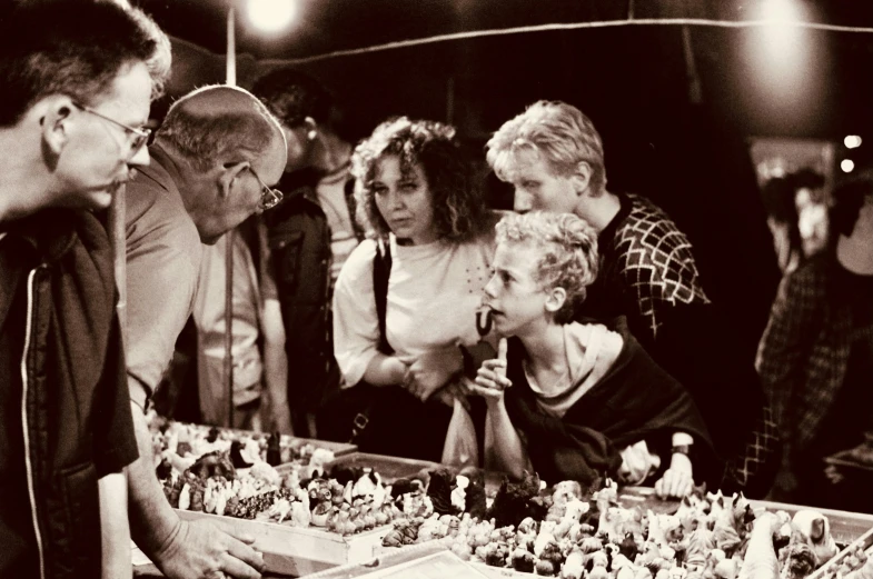 a group of people stand around a giant candy display