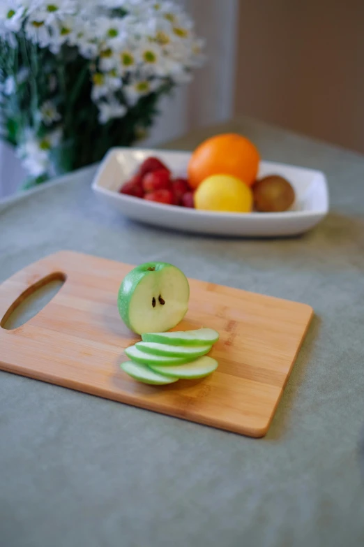 a wooden  board with an apple on it