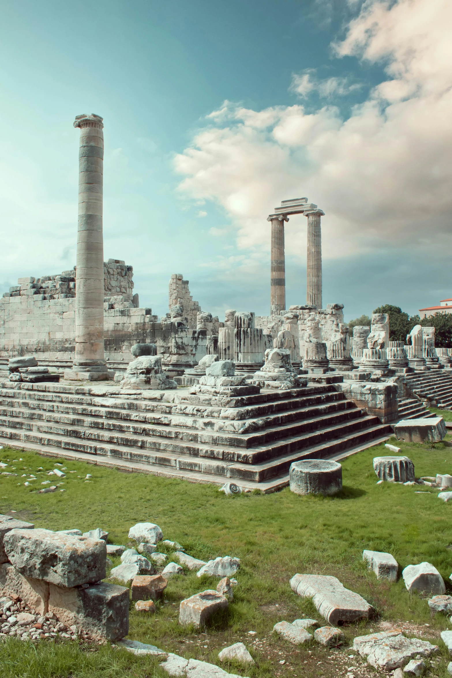 an ancient roman city with ruins and green grass