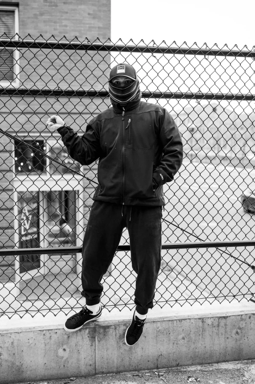 a skateboarder doing tricks on the side of a fence