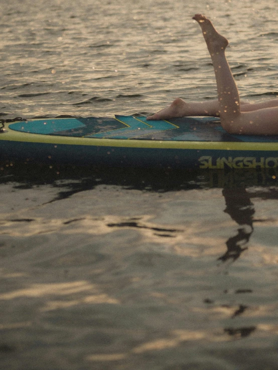 a man is laying on top of a surfboard in the ocean