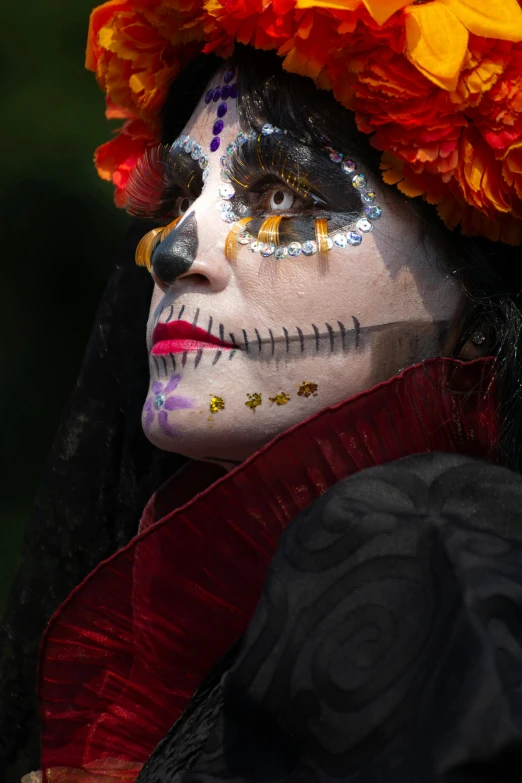 woman with a colorful headpiece made up of leaves and flowers