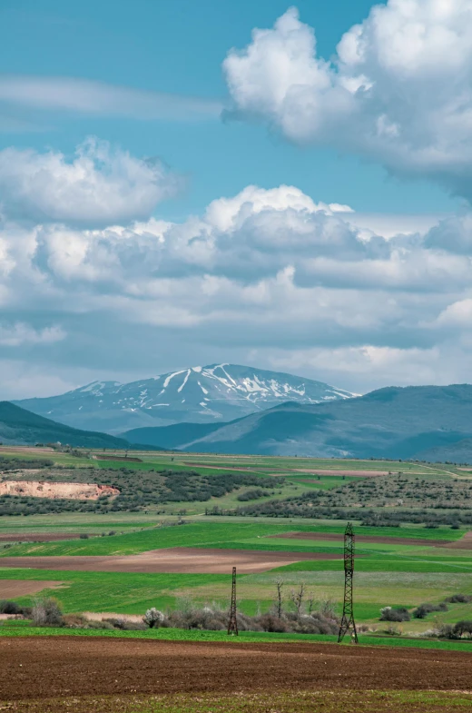 a lone windmill standing in an open field