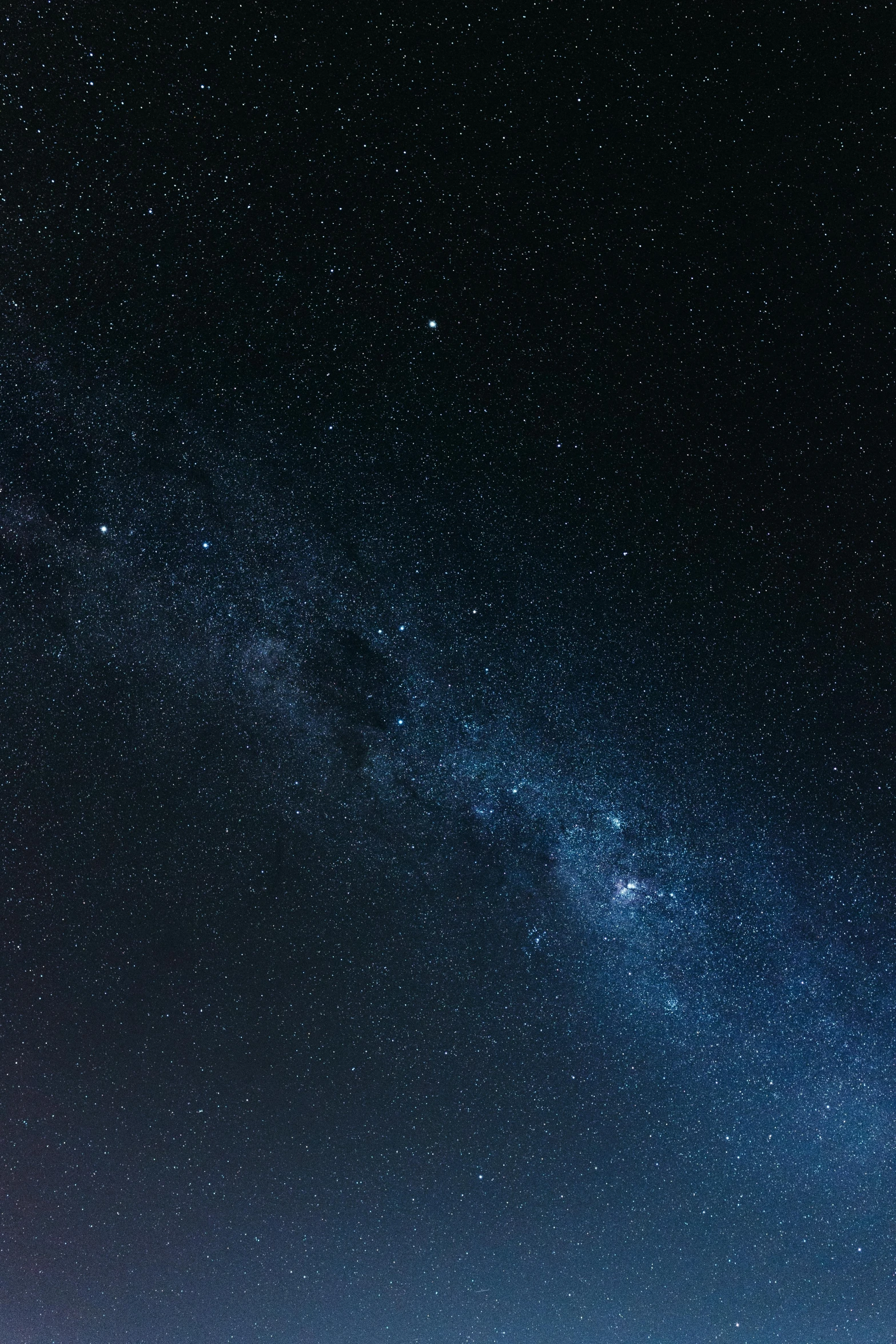 the view of many different stars over some mountains