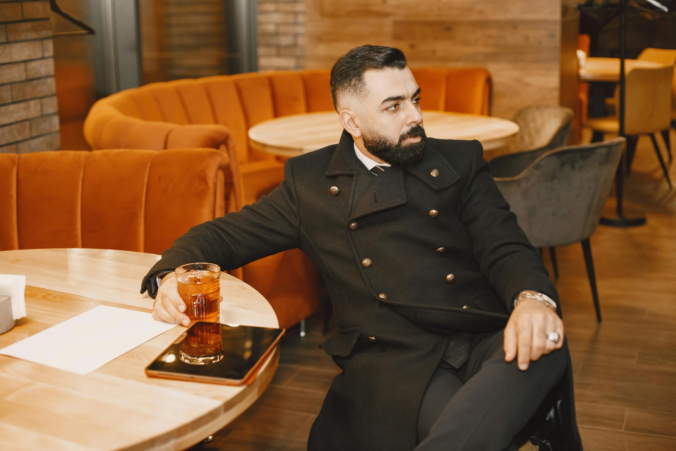 an image of a man sitting at a table with drinks