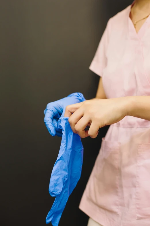 the woman holds a blue cloth on her left arm