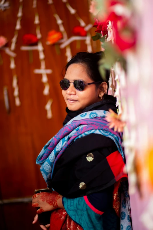 a woman with sunglasses on and a colorful outfit