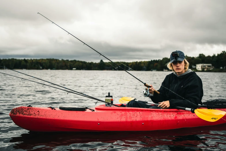 a man is fishing in the water with his kayak