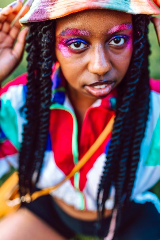 a young woman with face makeup and dreadlocks