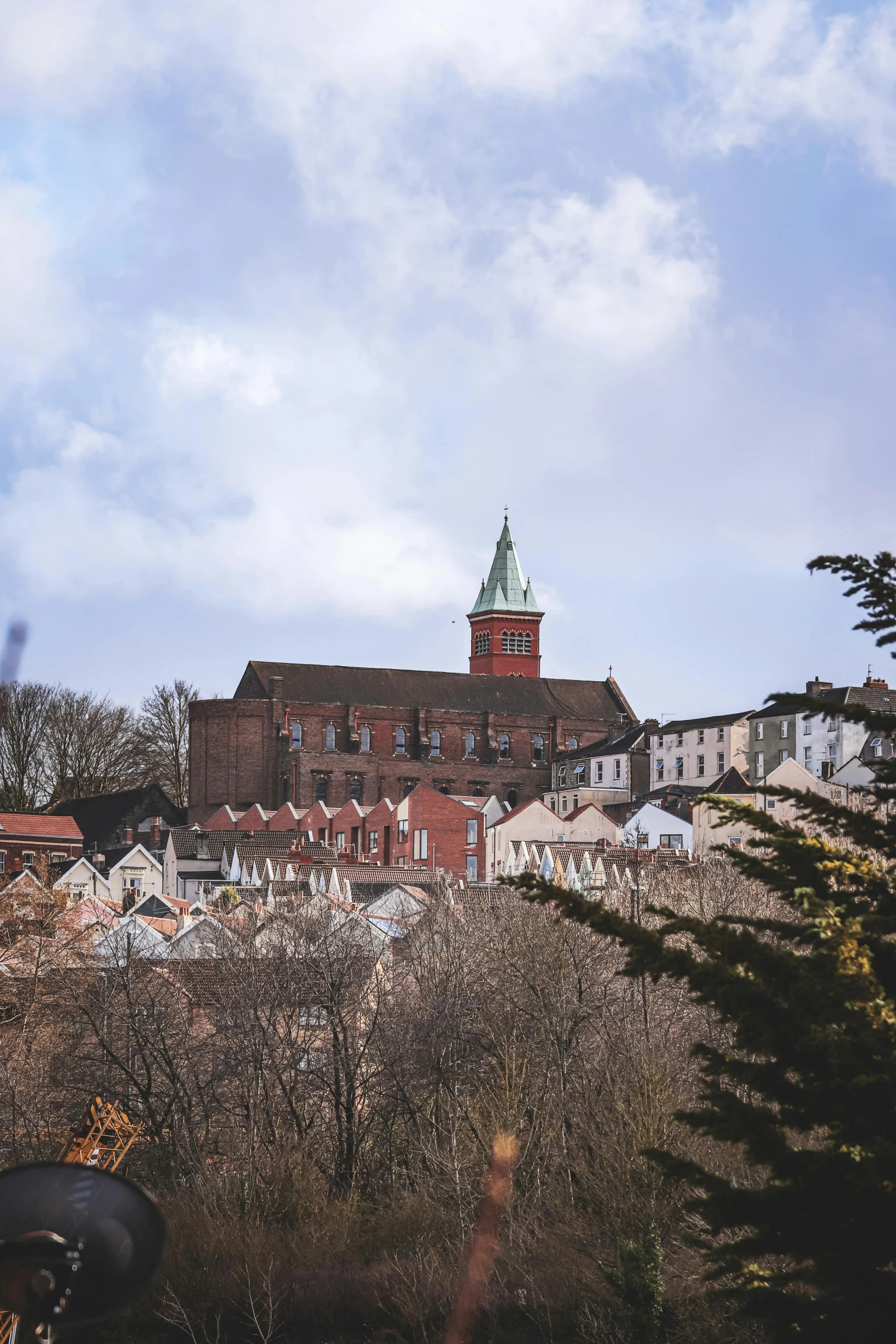 a church tower is shown with tall buildings behind it