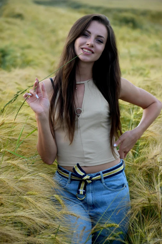a girl in high - waisted jeans posing for the camera