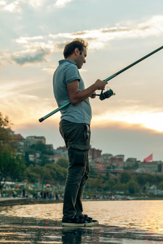 a man standing in water with fishing poles