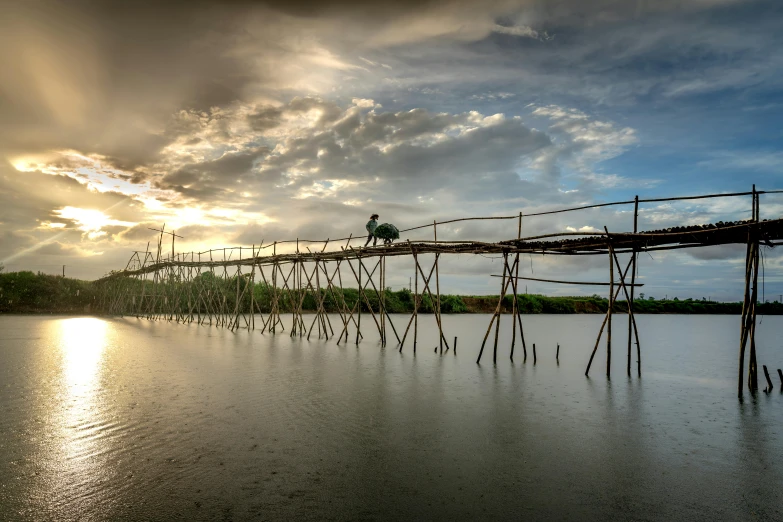 a man sitting on the end of a small pier