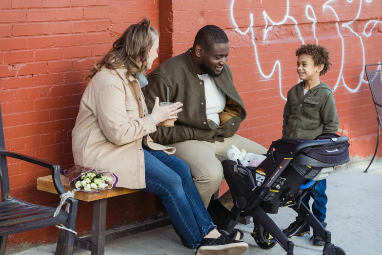 people sitting on a bench in front of a building