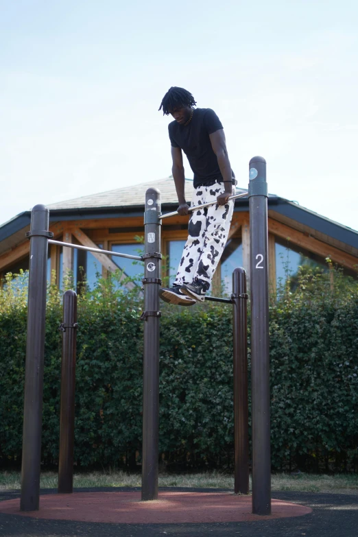 a man riding a skateboard on top of a wooden fence