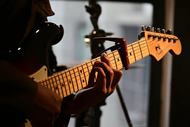 a close up view of a person playing an electric guitar