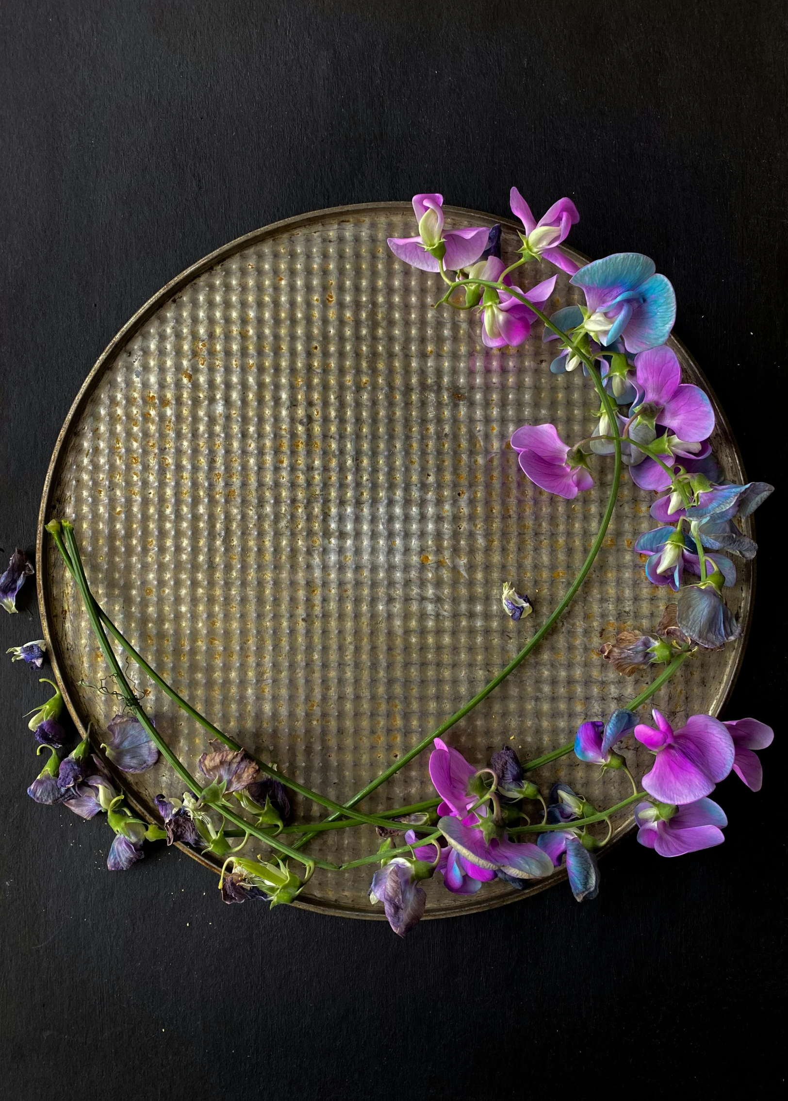 a flower wreath lies on a wooden surface