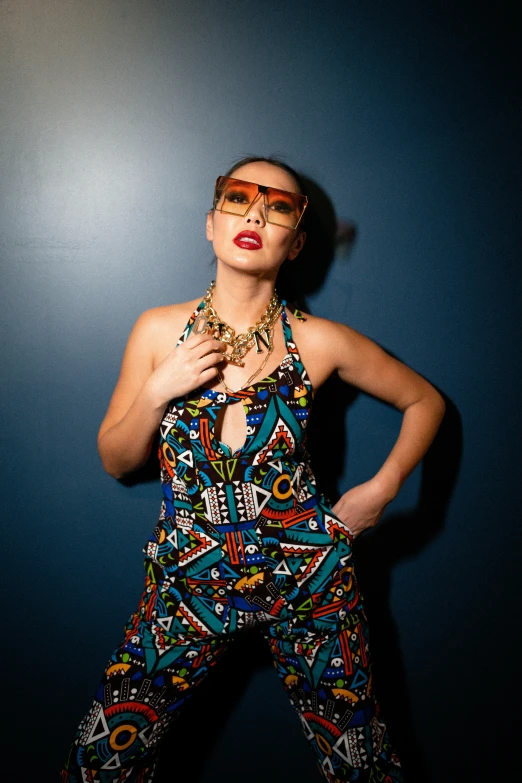 a beautiful woman posing with a colorful outfit