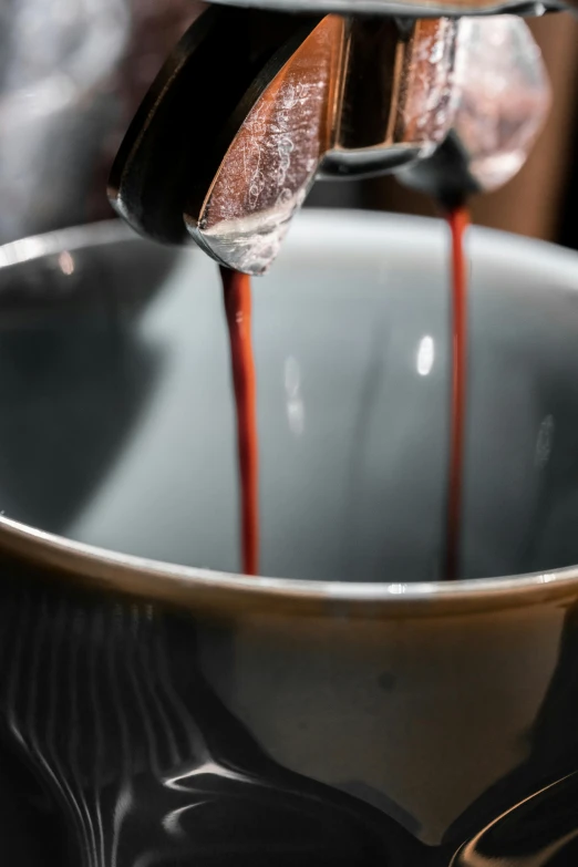 a cup filled with syrup is being filled by someone