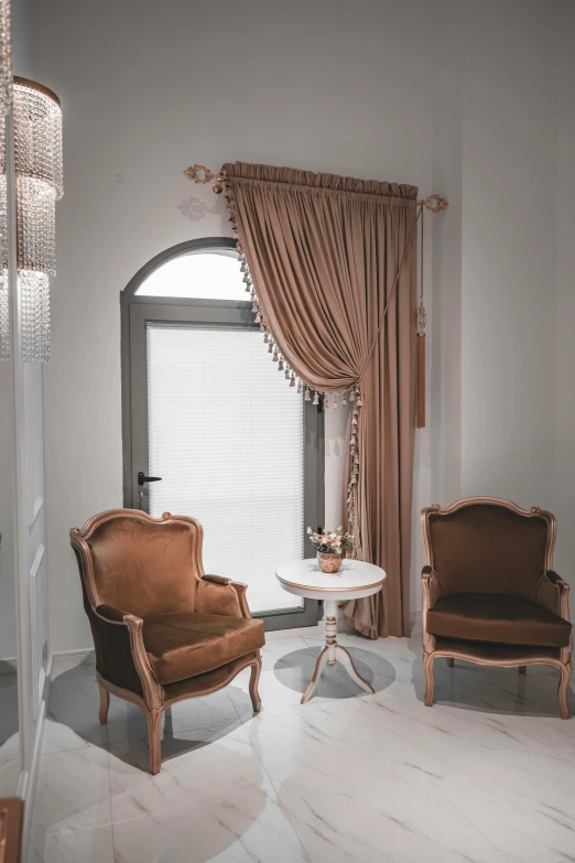 living room with two chairs sitting under an arch